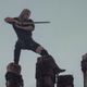 Geralt of Rivia practices his swordwork on a series of wooden poles against a gray sky.